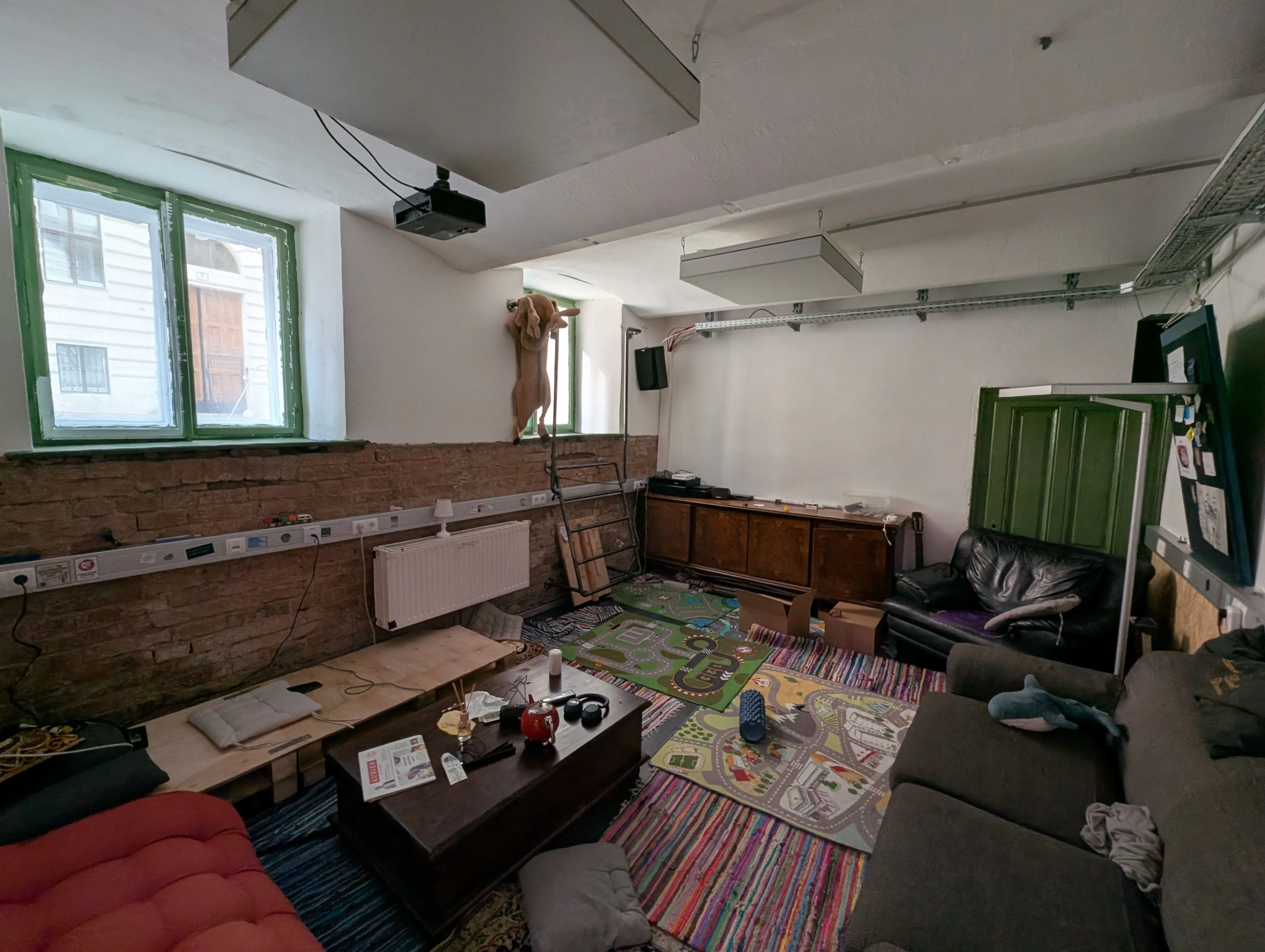 A comfy room with couches and carpets on the floor